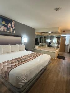 a hotel room with a large bed and a bathroom at Blue Star Motel in Chicago Ridge