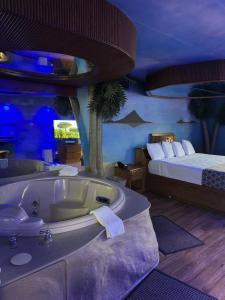 a bathroom with a bath tub and a bed at Blue Star Motel in Chicago Ridge