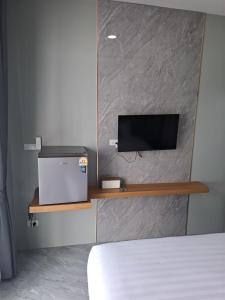 a bedroom with a bed and a tv on a wall at Adira Residence in Ao Nang Beach +24 photos