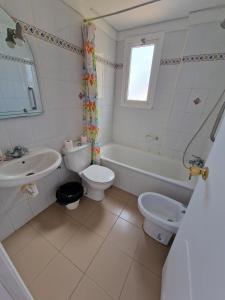 a bathroom with a sink and a toilet and a tub at brisa in Bajamar +14 photos
