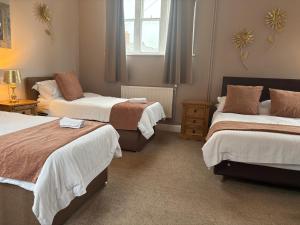 a bedroom with two beds and a window at The Berkeley Arms Hotel in Berkeley +27 photos