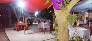 a group of tables and chairs on a street at night at JUNGLE GYM LA UNION Prana fan kubo 2 pax in Rimus +263 photos