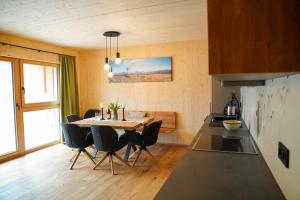 a kitchen and dining room with a table and chairs at Urlaub im Denkmal in Gröbming