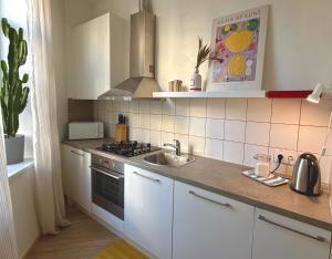 a kitchen with a sink and a stove at Bright Cozy Apartment in Riga Quiet Center in Riga