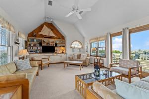 a living room with a couch and a table at 5592 - Windjammer in Nags Head