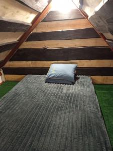 a mattress bed in a room with a roof at Гірська яфина in Myta