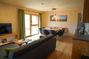 a living room with a couch and a table at Urlaub im Denkmal in Gröbming