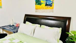 a bedroom with a bed with white pillows at Joshiehome in Rancho Cucamonga +3 photos