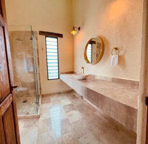 a bathroom with a sink and a shower at Hotel Suites Piamonte in Bernal