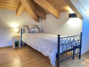 a bedroom with a bed in a room with wooden ceilings at My Sweet Home In The Dolomites - Casa LaLu in Cavalese