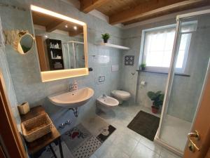 a bathroom with a sink and a toilet at My Sweet Home In The Dolomites - Casa LaLu in Cavalese +18 photos