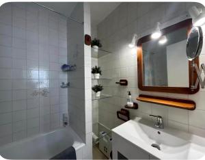 a bathroom with a sink and a tub and a mirror at Casa de playa los Alamos Andra in Torremolinos +53 photos