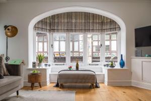 an archway in a living room with a large window at Tides Door in Dartmouth