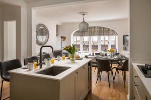 a kitchen and dining room with a dining table at Tides Door in Dartmouth