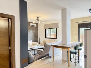 a kitchen and dining room with a table and chairs at Les Voiles Kfar Aabida in Fad‘ūs
