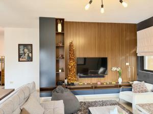 a living room with a couch and a christmas tree at Les Voiles Kfar Aabida in Fad‘ūs