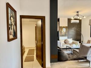 a hallway leading to a living room with a couch at Les Voiles Kfar Aabida in Fad‘ūs +12 photos