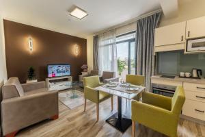 a kitchen and living room with a table and chairs at Liyu Hotel Apartment in Addis Ababa