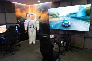 an astronaut is standing in front of a tv at Futurotel Space Spa Madrid Center in Madrid +94 photos