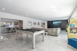a living room with a ping pong table at Guest Fav | 5BR Pool Estate | Sleeps 16 in Palmetto Bay
