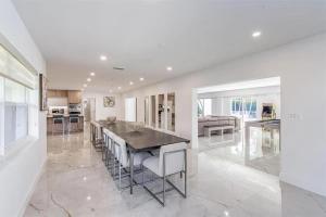 a kitchen and dining room with a table and chairs at Guest Fav | 5BR Pool Estate | Sleeps 16 in Palmetto Bay