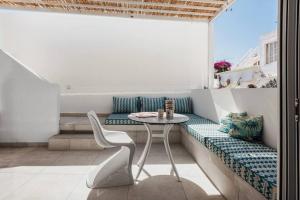 a balcony with a table and chairs in a room at Casa Sala - Private Rooftop Swiming Pool in Olhão