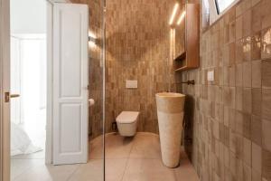 a bathroom with a toilet and a glass shower at Casa Sala - Private Rooftop Swiming Pool in Olhão +20 photos