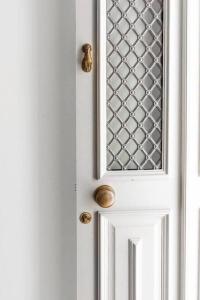 a white door with a window and brass knockers on it at Casa Sala - Private Rooftop Swiming Pool in Olhão