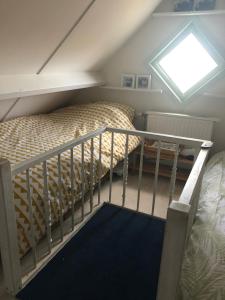 a attic bedroom with a bunk bed and a window at De Knol in Hoek