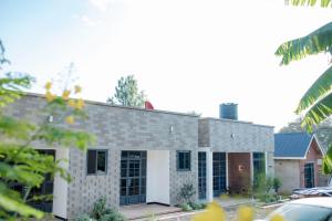 a large brick building with a garage at Kilistone Apartments in Uru