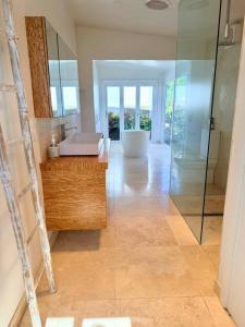 a bathroom with a tub and a sink and a mirror at Shorebreak Port Campbell in Port Campbell +28 photos