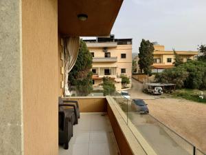 a balcony with a view of a building at Les Palmiers Kfar Aabida in Fad‘ūs