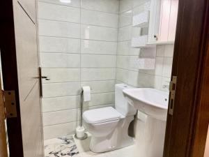 a small bathroom with a toilet and a sink at Les Palmiers Kfar Aabida in Fad‘ūs +8 photos