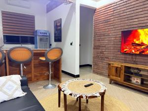 a living room with a couch and a tv at Kilistone Apartments in Uru
