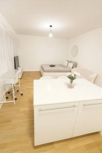 a white living room with a couch and a bed at Chailly The Minimalist Lausanne in Lausanne