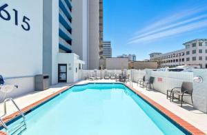 a swimming pool on the roof of a building at New Beachfront Condo Pool Surfing Fishing in Virginia Beach