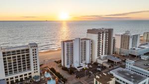an aerial view of a beach with buildings and the ocean at New Beachfront Condo Pool Surfing Fishing in Virginia Beach