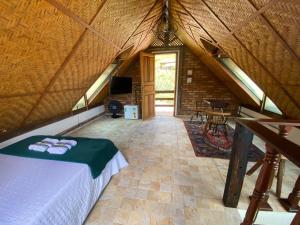 a bedroom in a tent with a bed and a table at Chalé Ouro in Ouro Preto