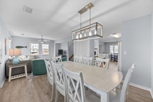 a dining room and living room with a table and chairs at 7767 - Swordfish in Buxton +40 photos