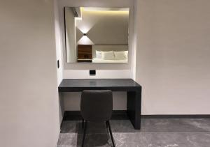 a room with a desk with a mirror and a chair at Hotel Suites Regente Cholula in Cholula
