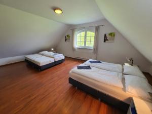 a bedroom with two beds and a window at Villa Rezort Vlašky in Bešeňová