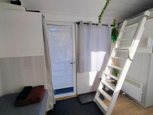 a room with a ladder next to a door at Koidula Tiny House in Narva-Jõesuu