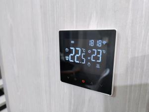 a clock on the side of a refrigerator at Koidula Tiny House in Narva-Jõesuu +12 photos