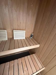 a sauna with two benches and a cell phone on it at Hausboot Nikolai Stralsund in Stralsund