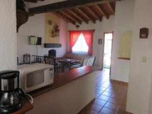 a kitchen and living room with a microwave on a counter at Rincones de Tequis in La Tortuga