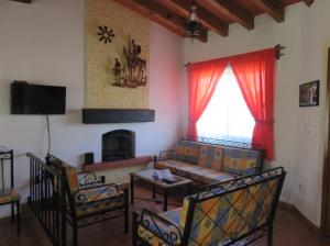 a living room with a couch and a fireplace at Rincones de Tequis in La Tortuga