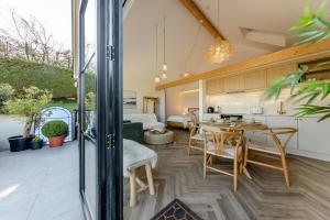 a kitchen and living room with a table and chairs at 1 Bed in Llanmorlais oc-p35002 in Penclawdd +19 photos