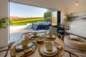a living room with a table and a large window at 1 Bed in Llanmorlais oc-p35002 in Penclawdd