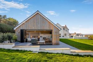 a barn style house with a patio and a backyard at 1 Bed in Llanmorlais oc-p35002 in Penclawdd