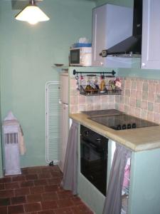 a kitchen with a sink and a stove top oven at The Nut House in La Garde-Freinet